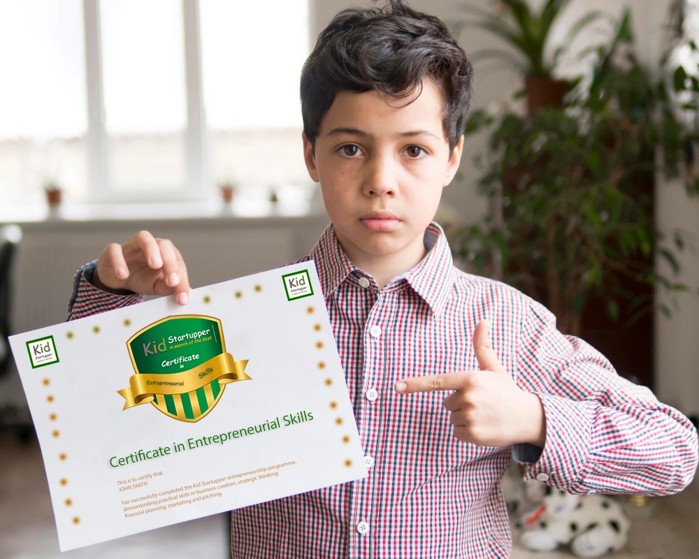 A student receiving their Kid Startupper certificate